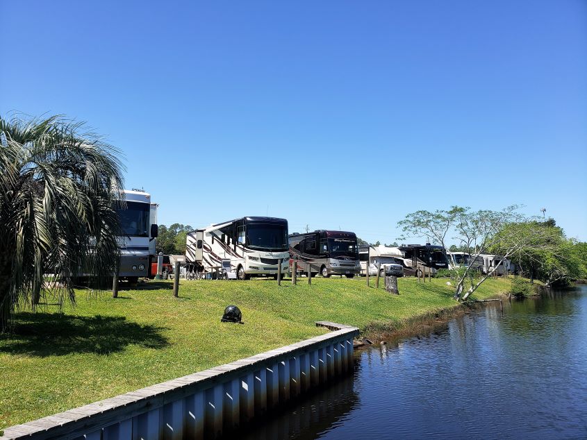 Image of RV's camping on campsites on waterfront.